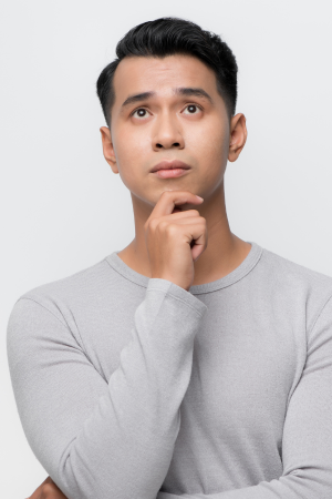 Young man thinking with his hand on his chin